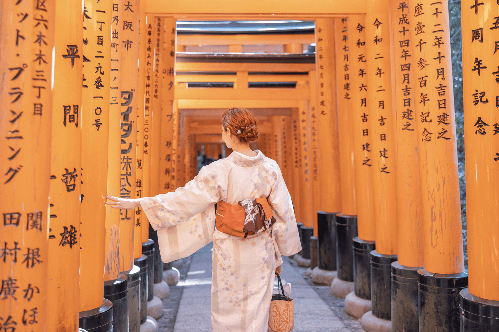 Kalu vestindo kimono entre os milhares de portões vermelhos no Fushimi Inari Taisha.